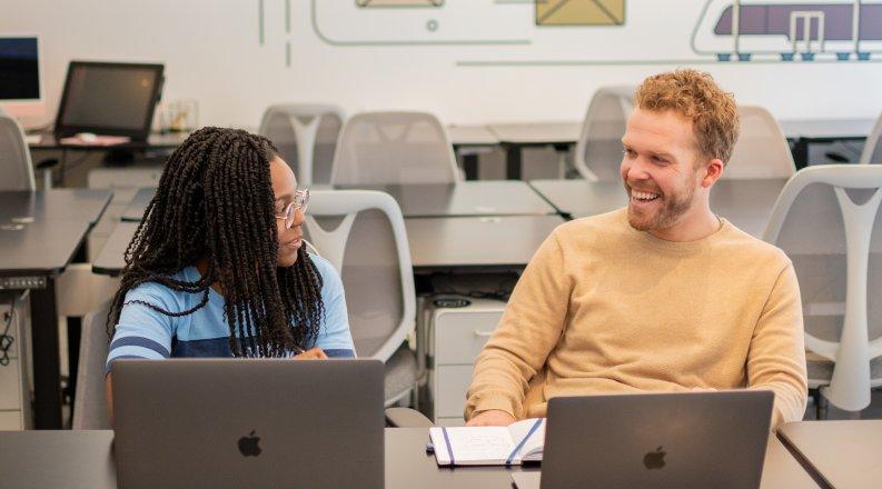 Students talking at desk
