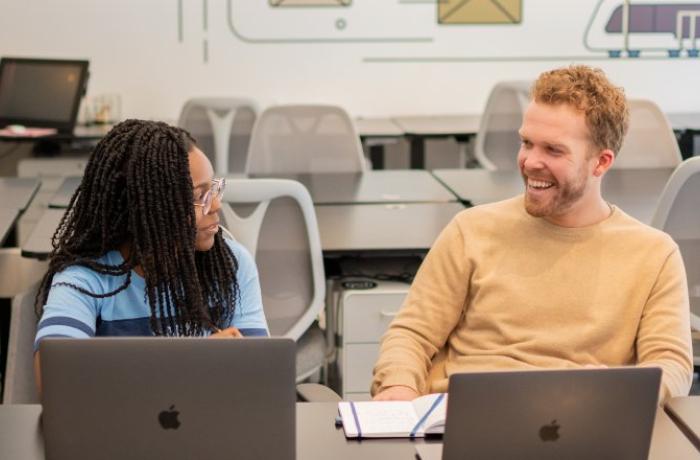 Students talking at desk